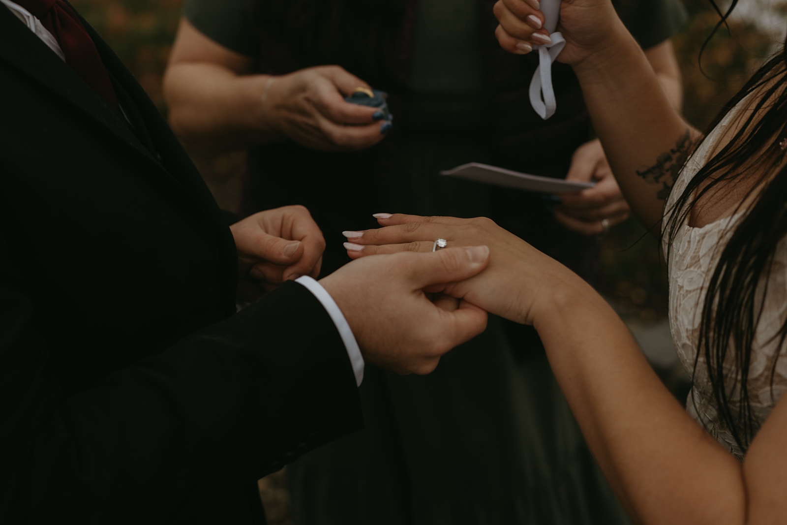 Groom placing a ring on the bride’s finger during a heartfelt moment of the ceremony.