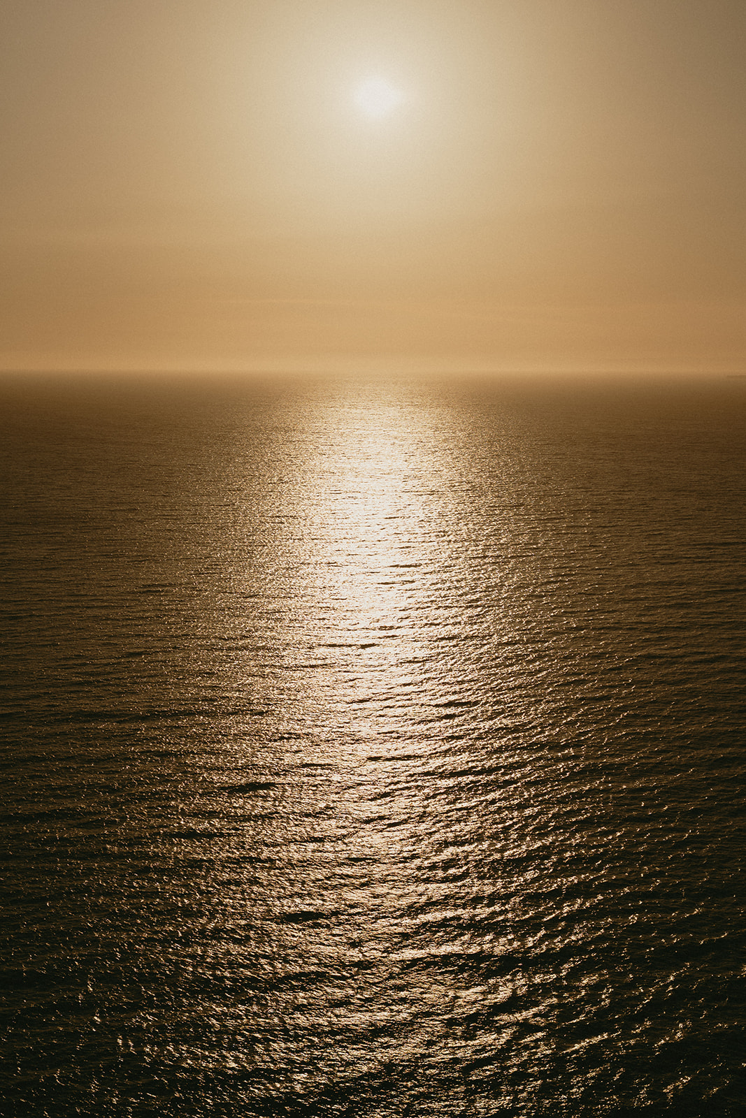 Peaceful ocean view at sunset, with golden light reflecting across the water near Whidbey Island.