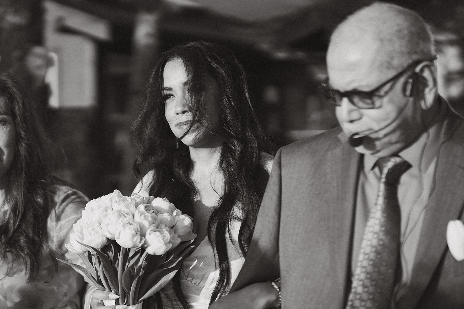 Emotional moment as the bride walks down the aisle with her father, bouquet in hand.