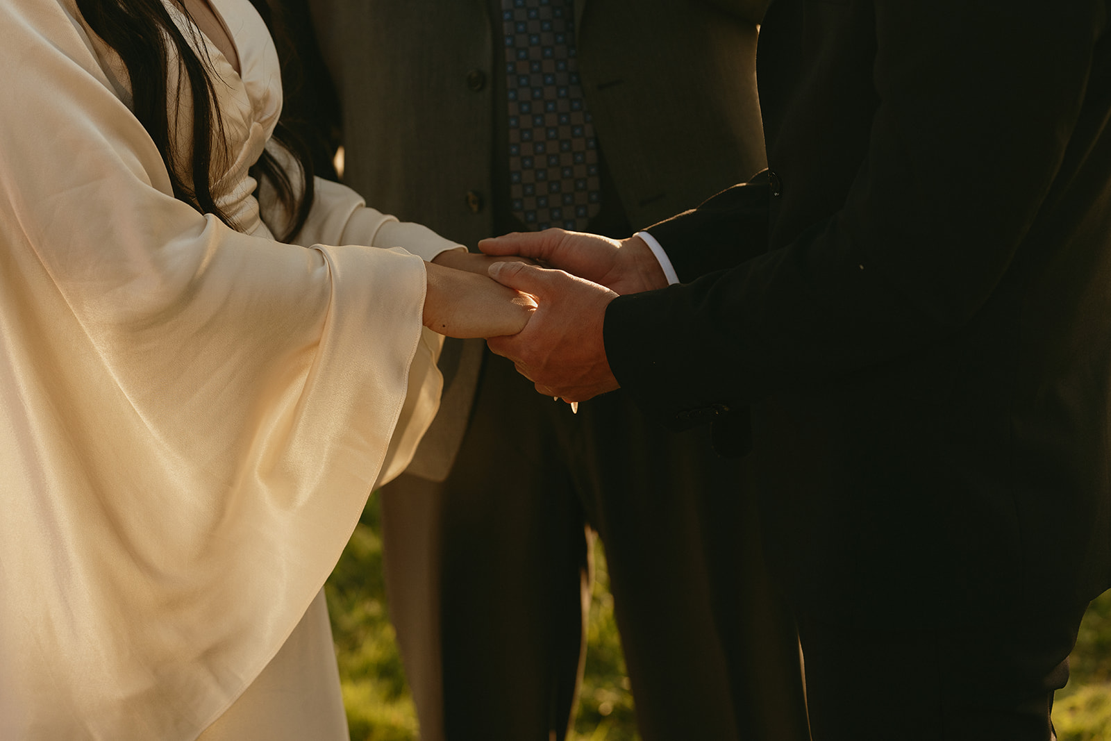 Close-up of the couple holding hands during their Whidbey Island wedding ceremony. 
