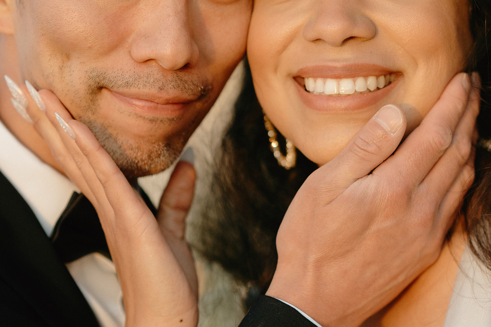 Close-up of a smiling couple gently holding each other's faces, radiating joy and connection after their Whidbey Island wedding. 