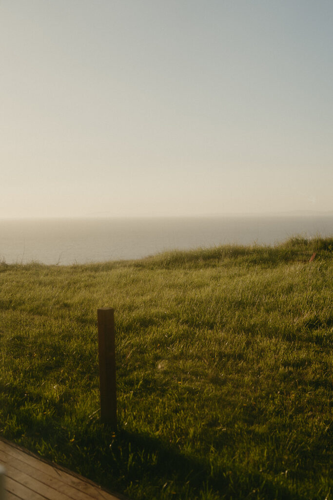 Coastal view of a grassy bluff overlooking the Puget Sound, captured at sunset on Whidbey Island.