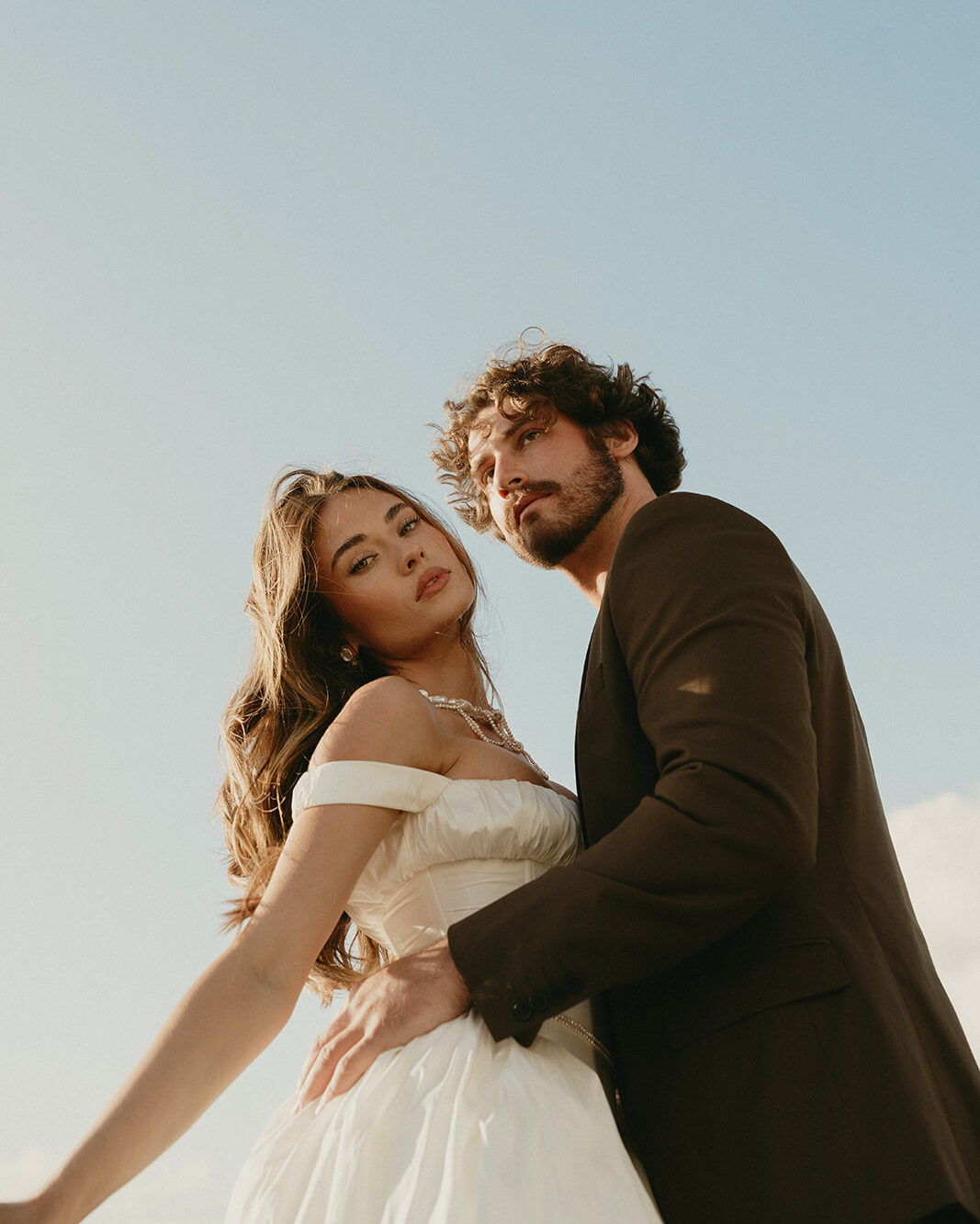 Close-up of bride and groom embracing softly at the edge of the beach, captured during their Oregon Coast elopement.
