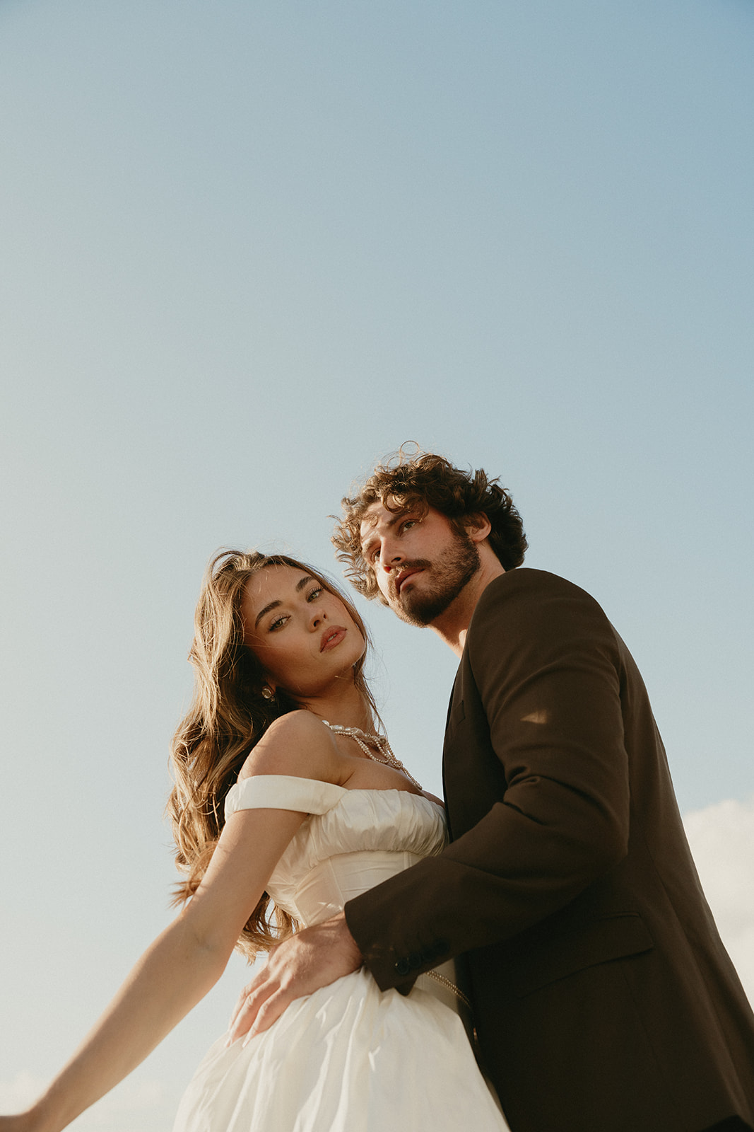 Close-up of bride and groom embracing softly at the edge of the beach, captured during their Oregon Coast elopement.