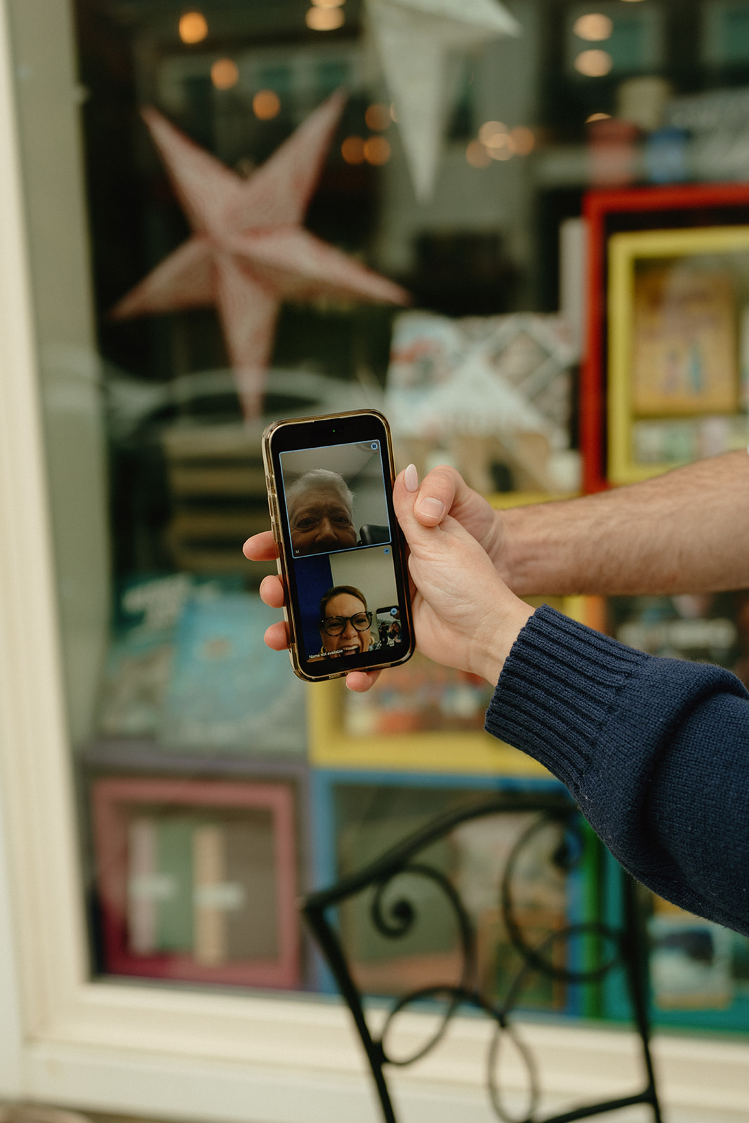 Phone held up during a video call, sharing the engagement news with family—capturing meaningful connection and ideas for engagement photos that feel personal.