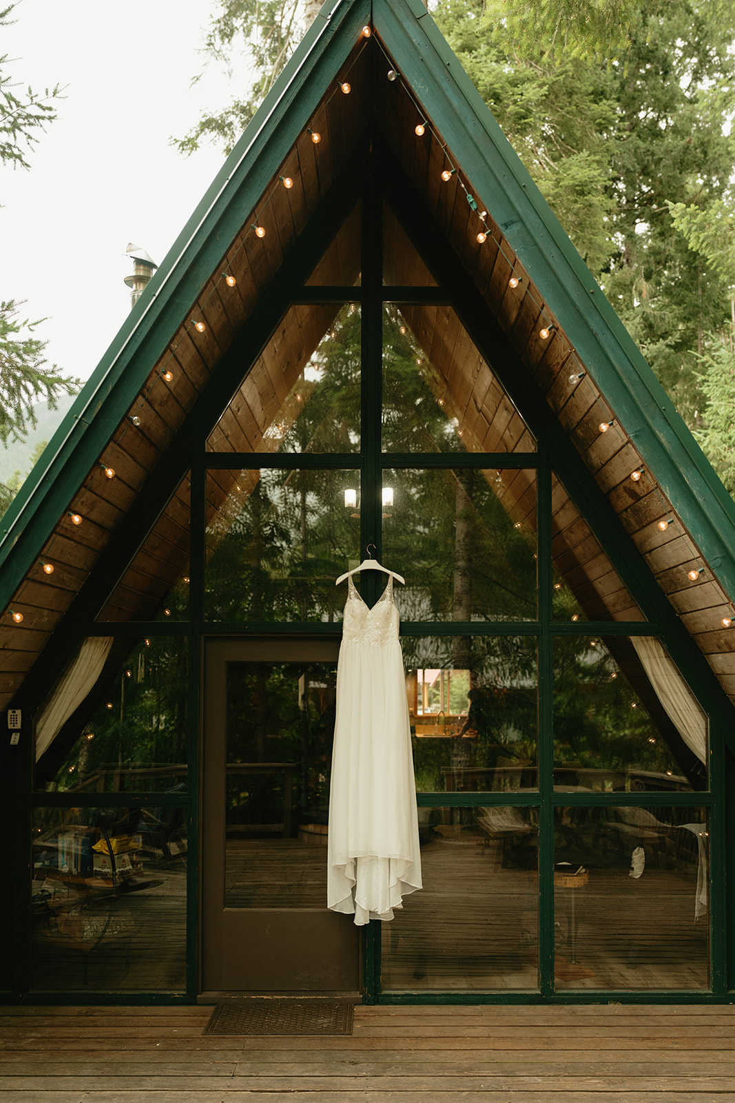 Wedding gown hanging from top of A-Frame cabin in Mount rainier