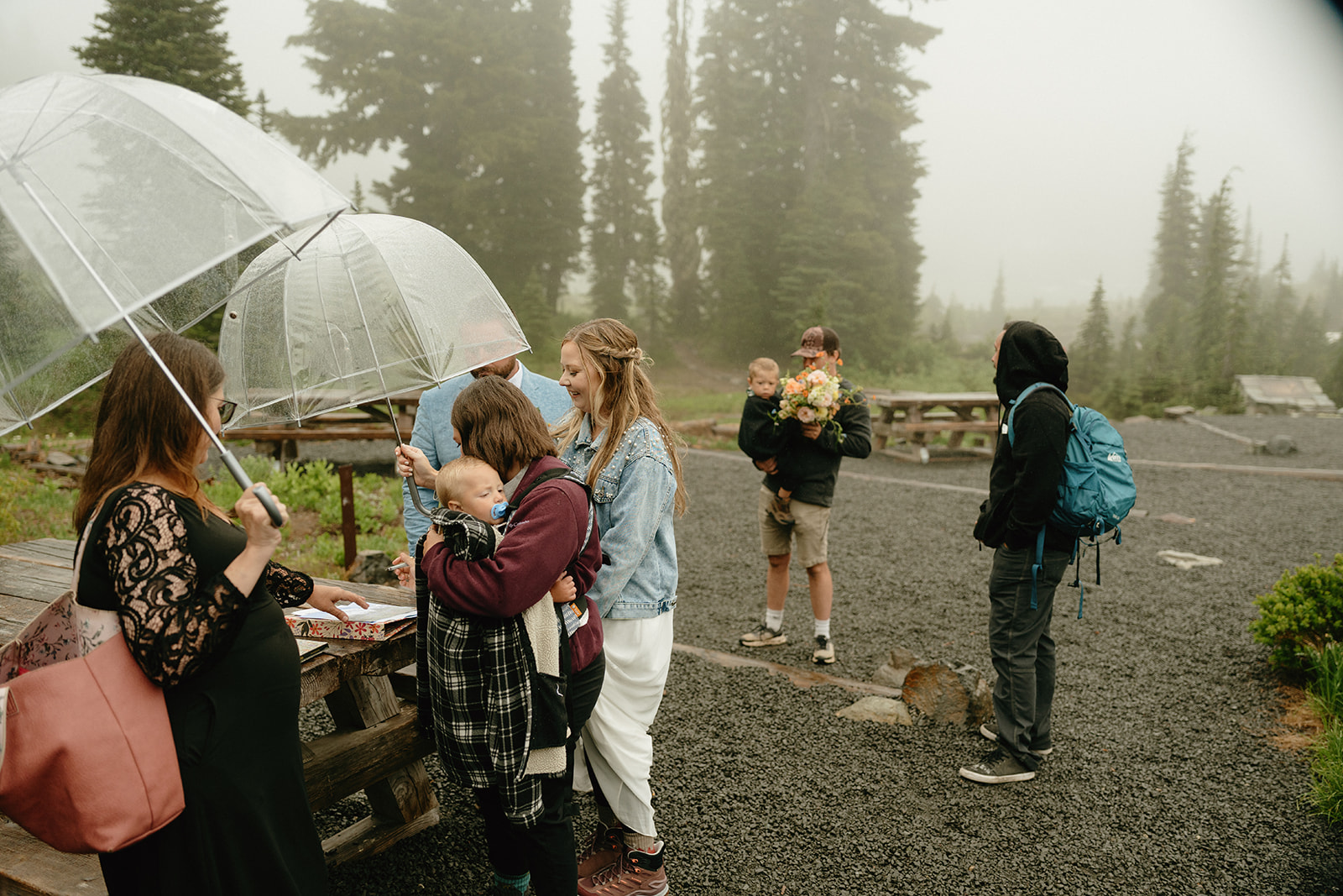 Bride and groom surrounded by close friends and family after intimate elopement celebrating