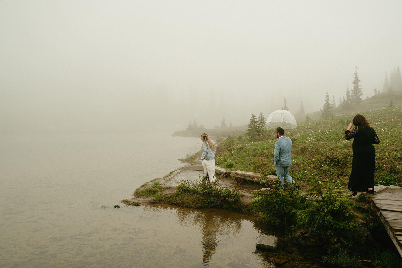 Bride and groom walking towards dock near water before intimate elopement at Mount Rainier National Park
