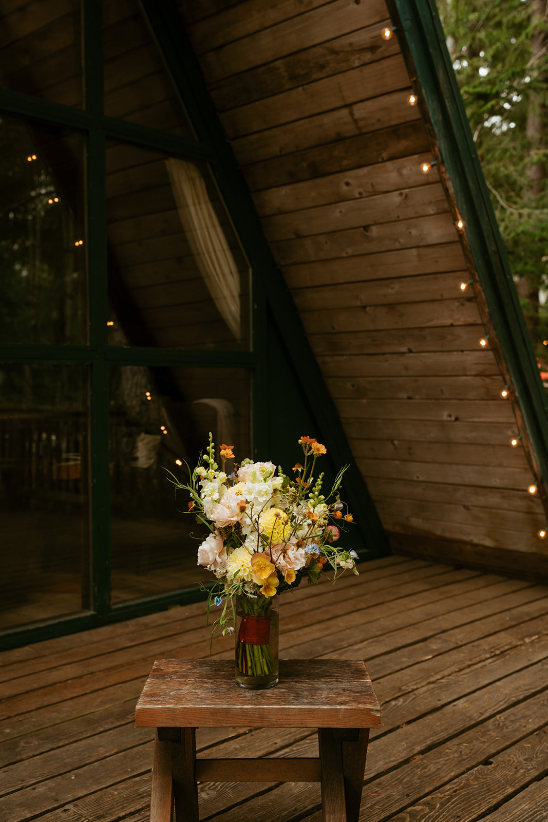 Bridal bouquet sitting in vase of water before intimate elopement