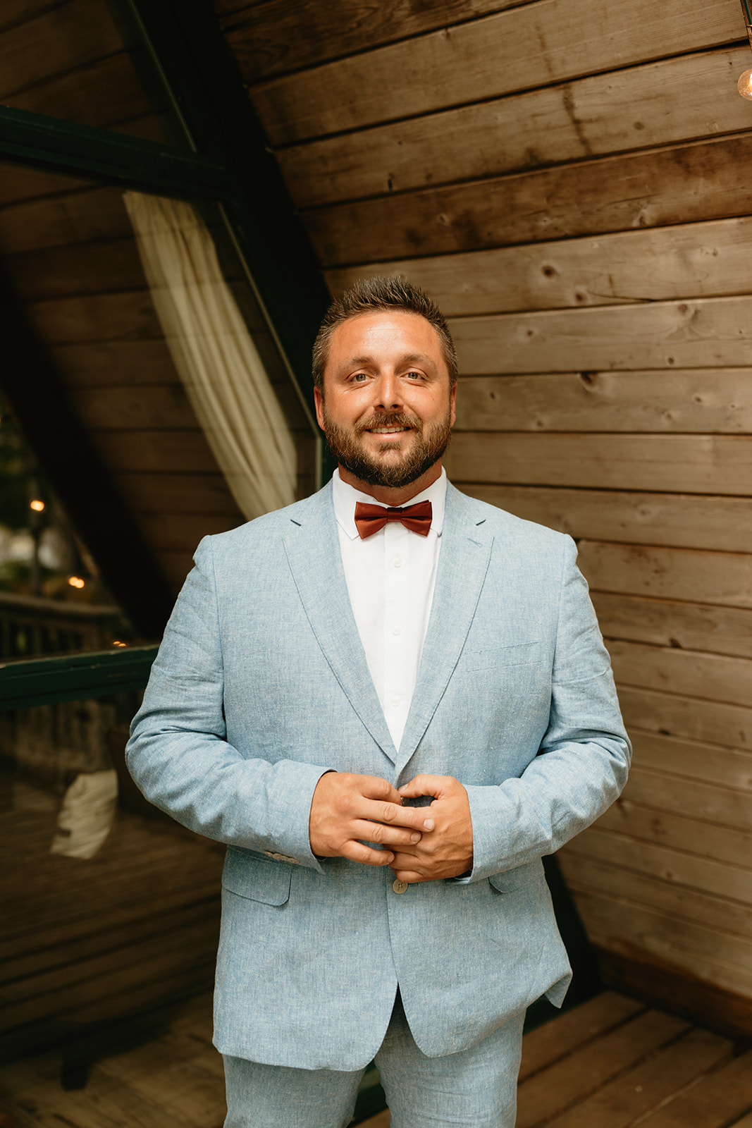 Groom wearing blue suit and red bowtie before intimate Mount Rainier National Park elopement