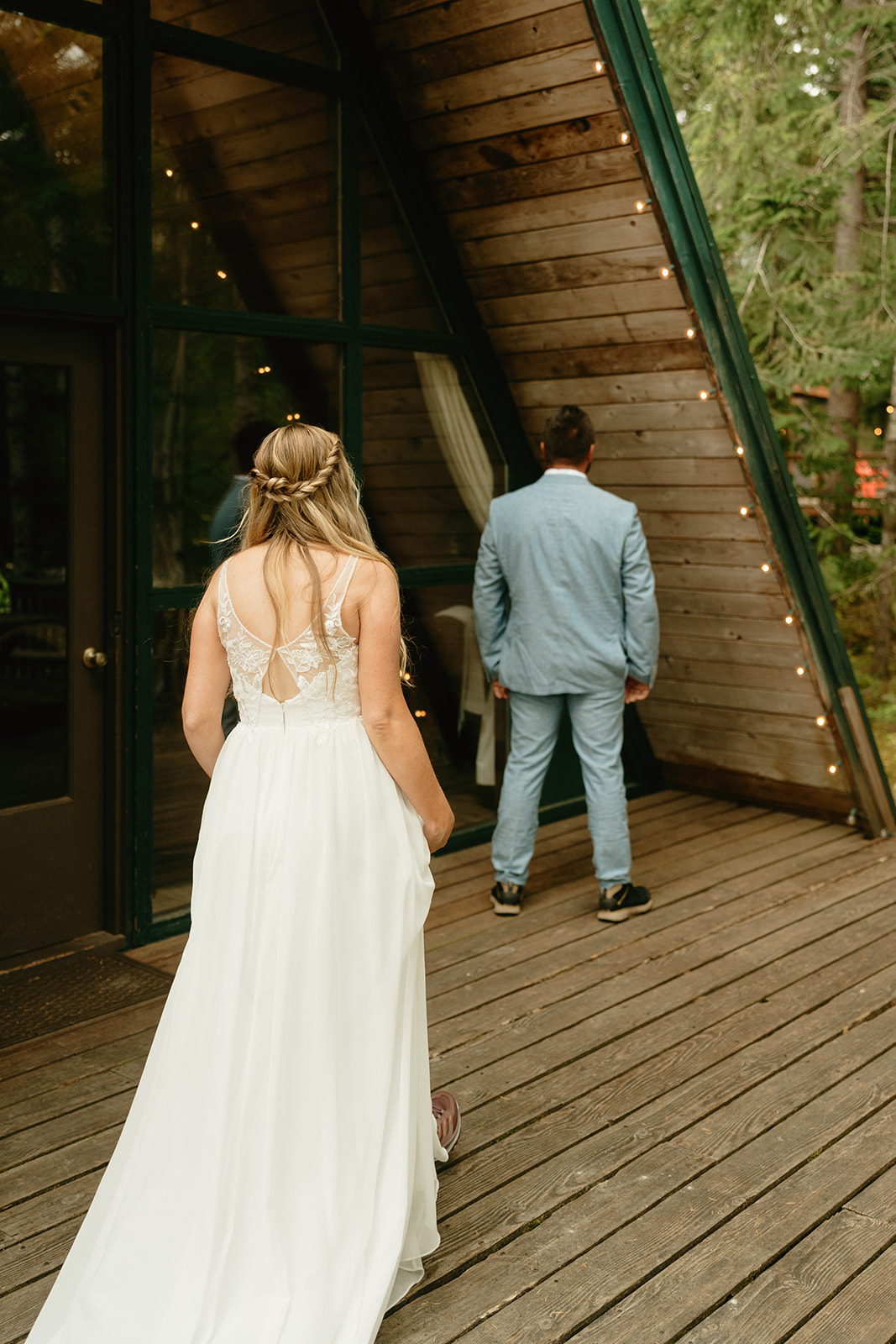 Bride walking up to groom in powder blue suit during first look