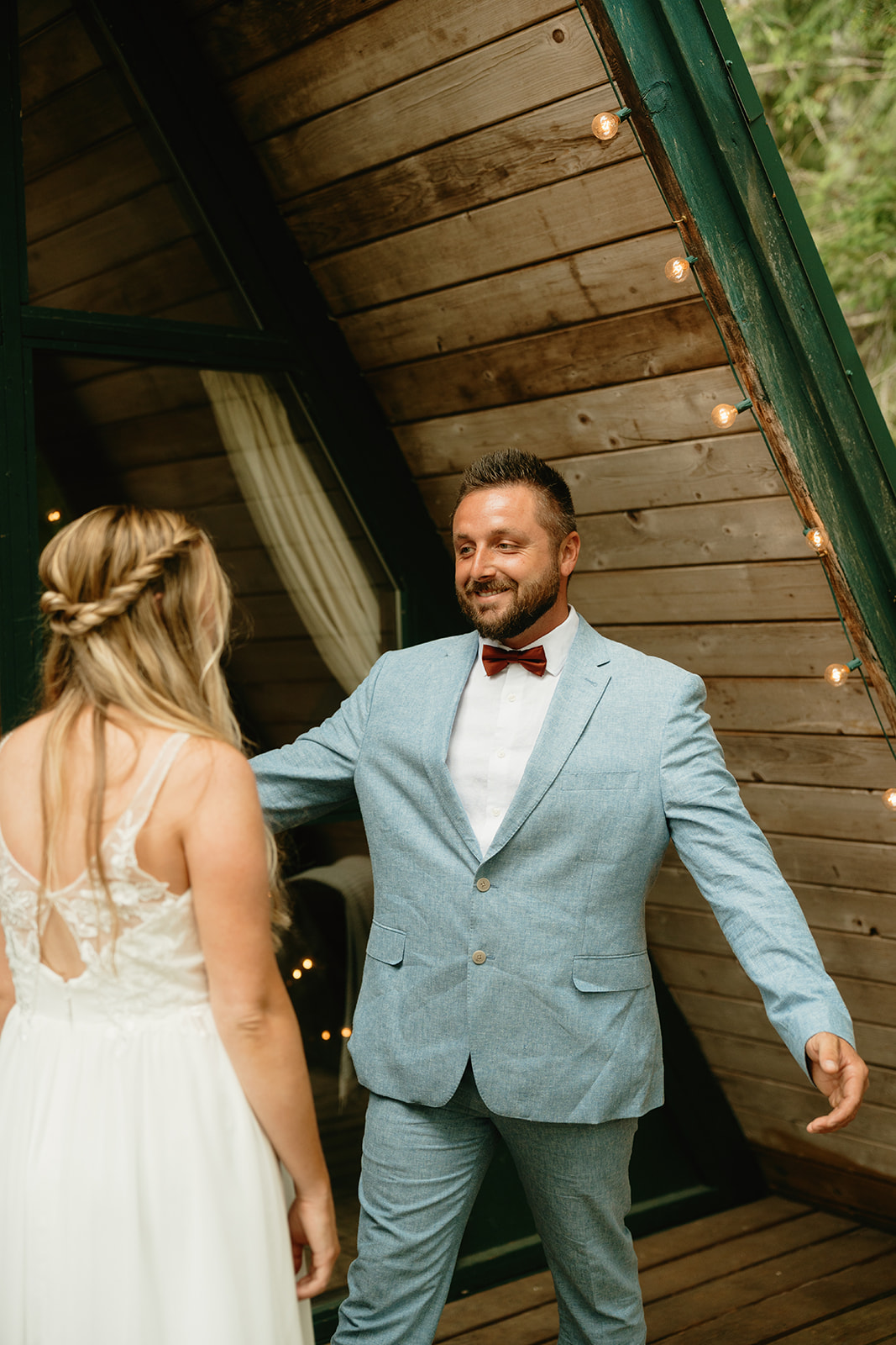 Groom in powder blue suit walks towards bride to embrace her during first look