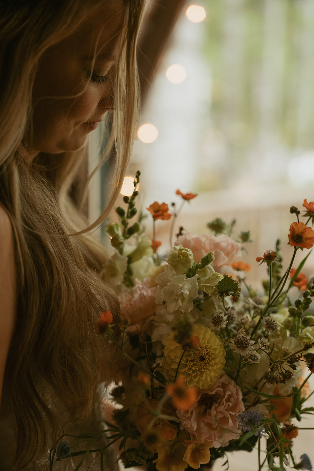 Close up of bride looking down at her bridal bouquet after Mount Rainier national park elopement
