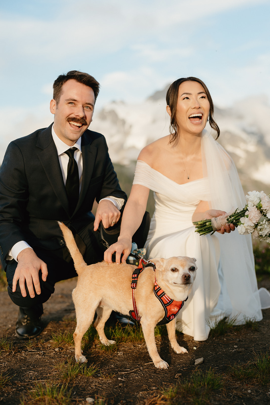 Joyful couple poses with their dog at their Mount Baker elopement.