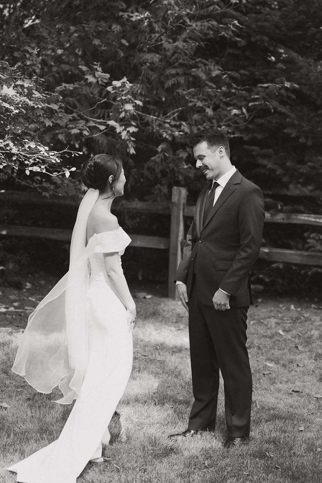 Groom seeing his bride for the first time during an intimate first look in the forest.