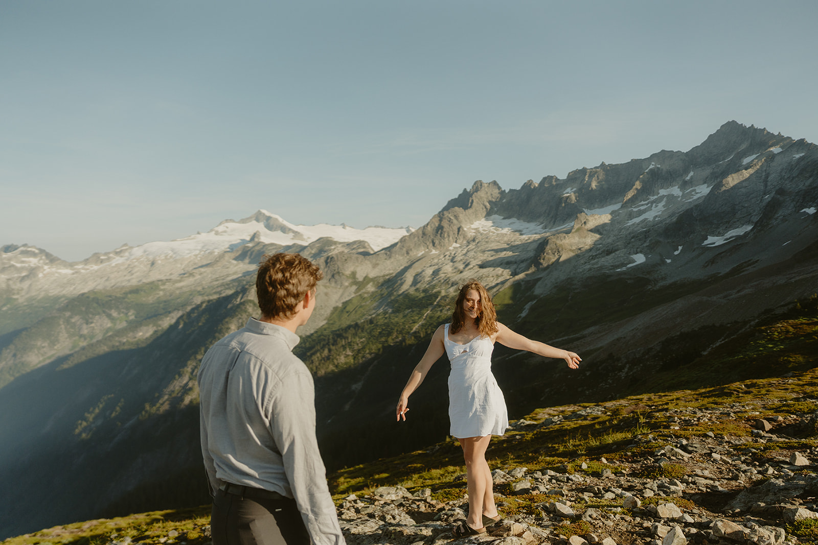 A couple poses together in a scenic mountain setting during their engagement session in Washington
