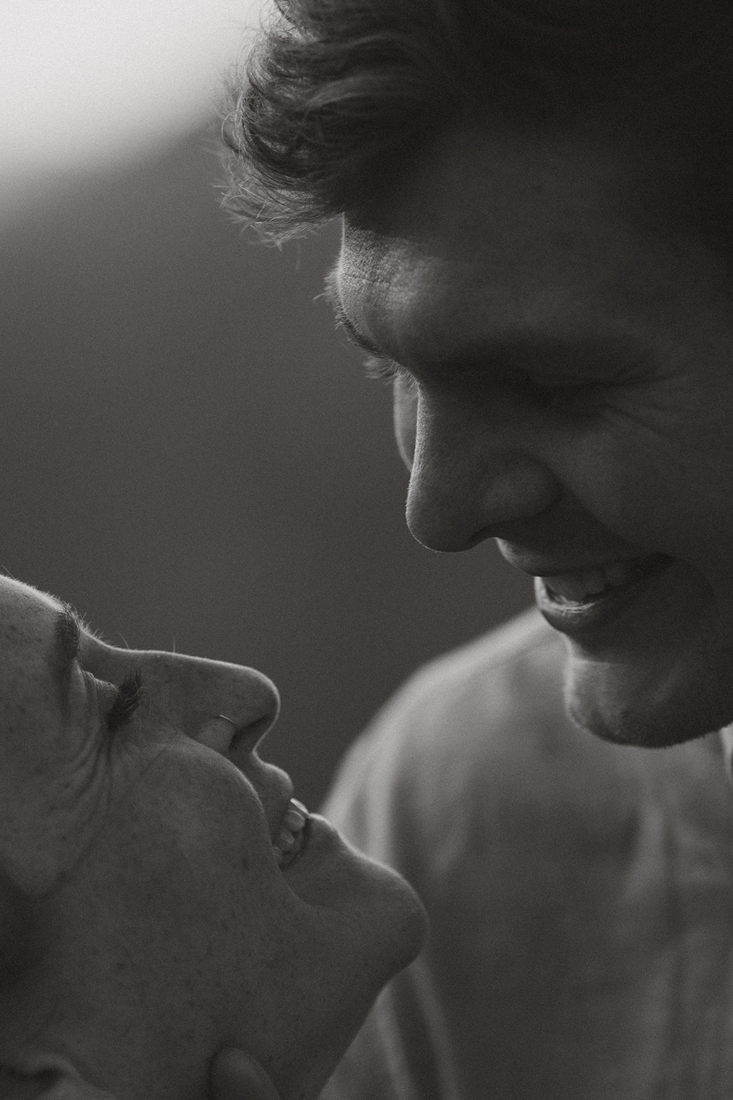 A man and woman are smiling together, showcasing a moment of joy and connection.