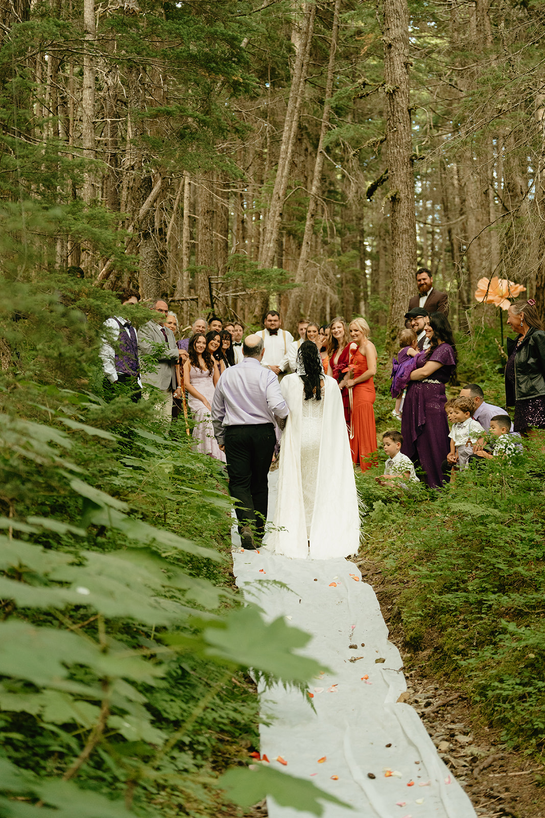Bride walking with father down the aisle to meet her groom before eloping to Alaska ceremony begins