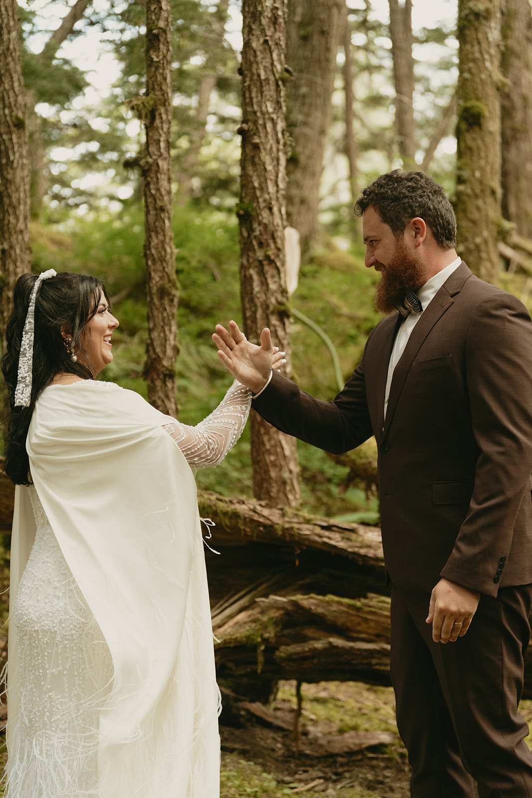 Bride and groom do fun handshake after eloping to Alaska to celebrate their recent marriage