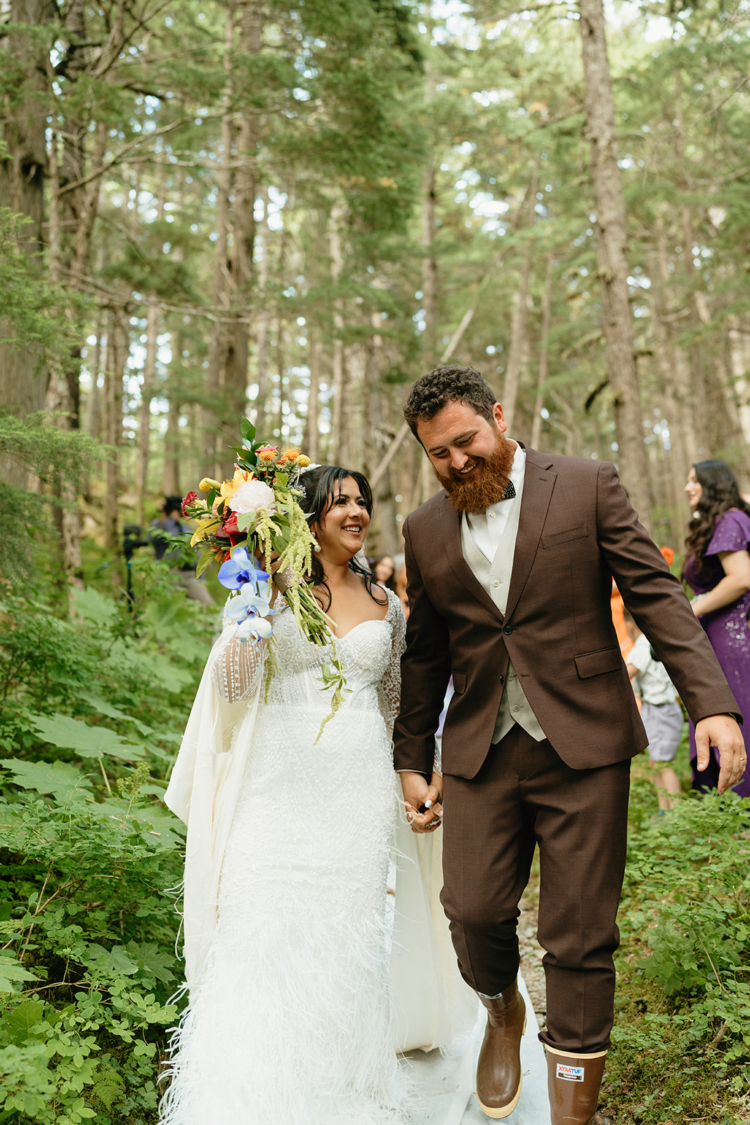 Bride and groom exit wedding ceremony joyfully as a newly married couple filled with excitement.