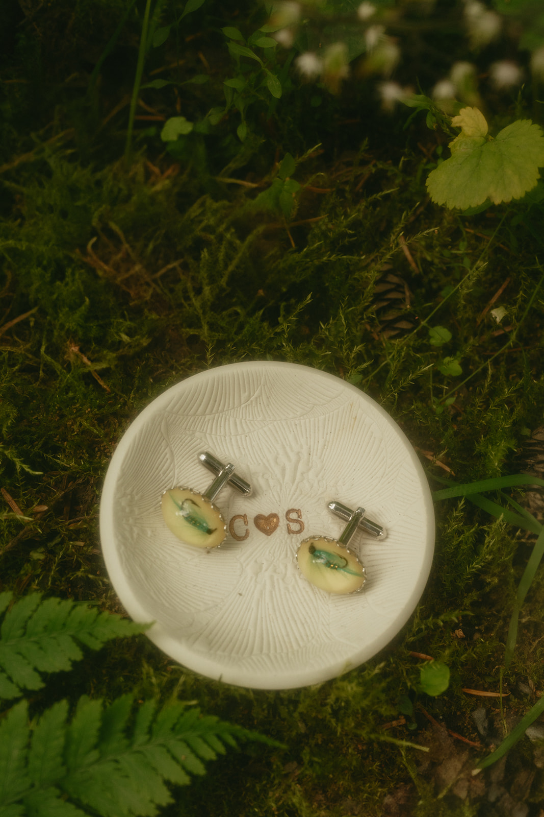 Close up of custom ring dish with cufflinks sitting in it.