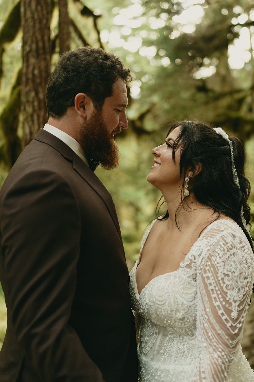 Close up of couple looking at one another with smiles on their faces celebrating their recent marriage.
