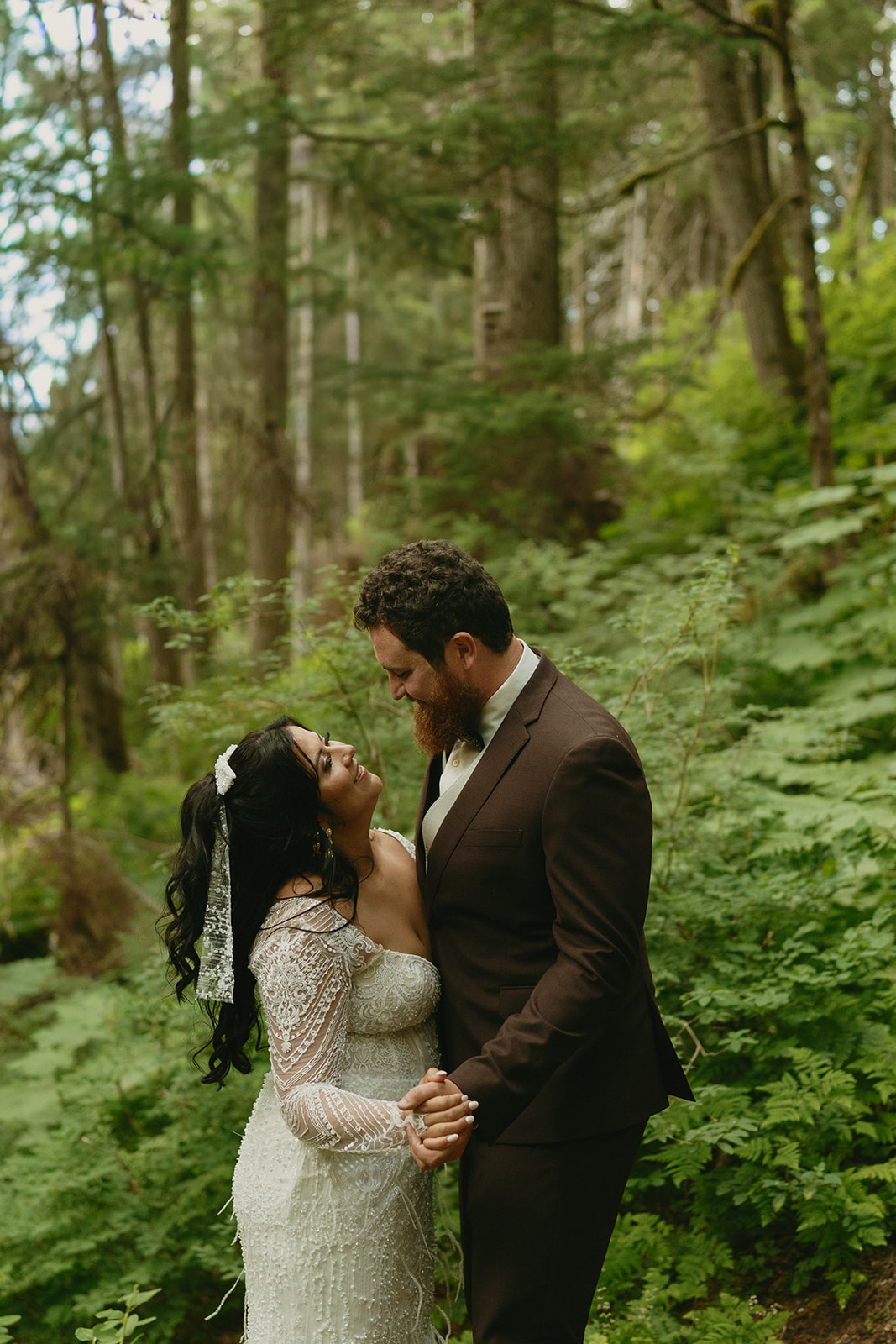 Bride and groom dance together in private first dance in forest of Alaska