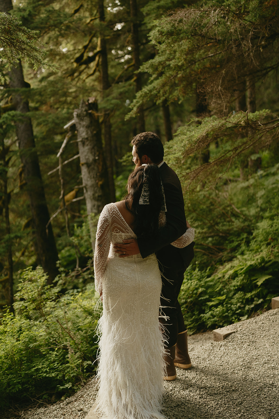 Couple looks over at landscape and views while embracing