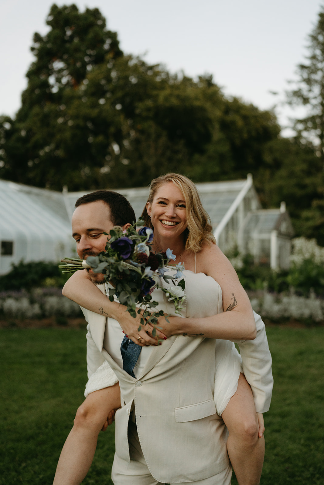 layful moment between newlyweds during golden hour at a lush wedding venue in Washington.
