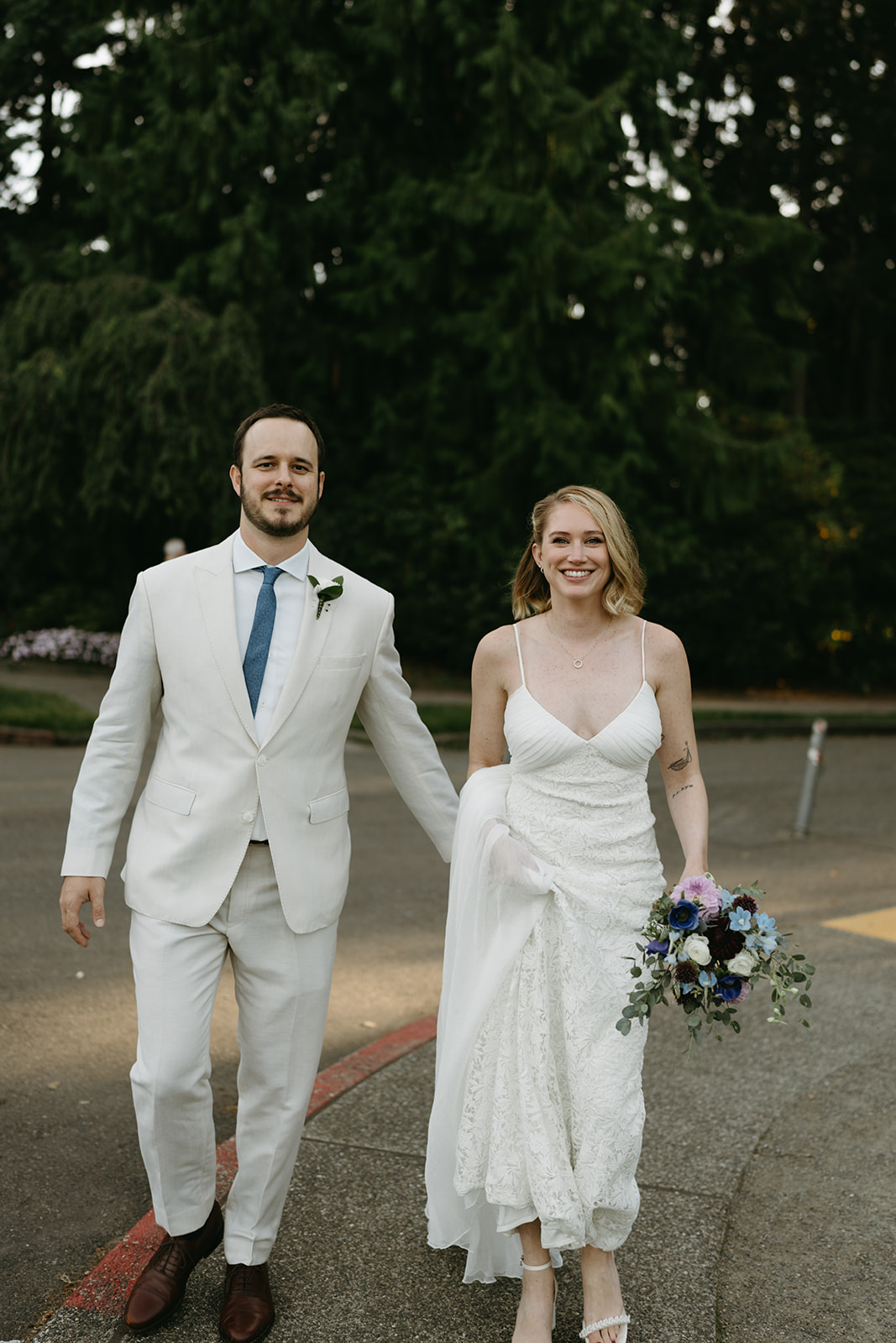 Bride and groom walking joyfully hand-in-hand after their ceremony at a peaceful wedding venue in Washington.