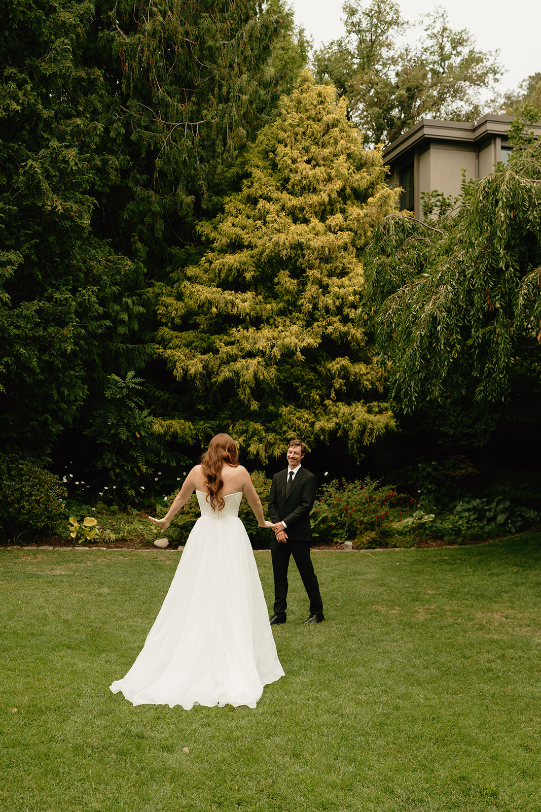 Joyful connection as the bride and groom meet in a quiet garden for their first look.