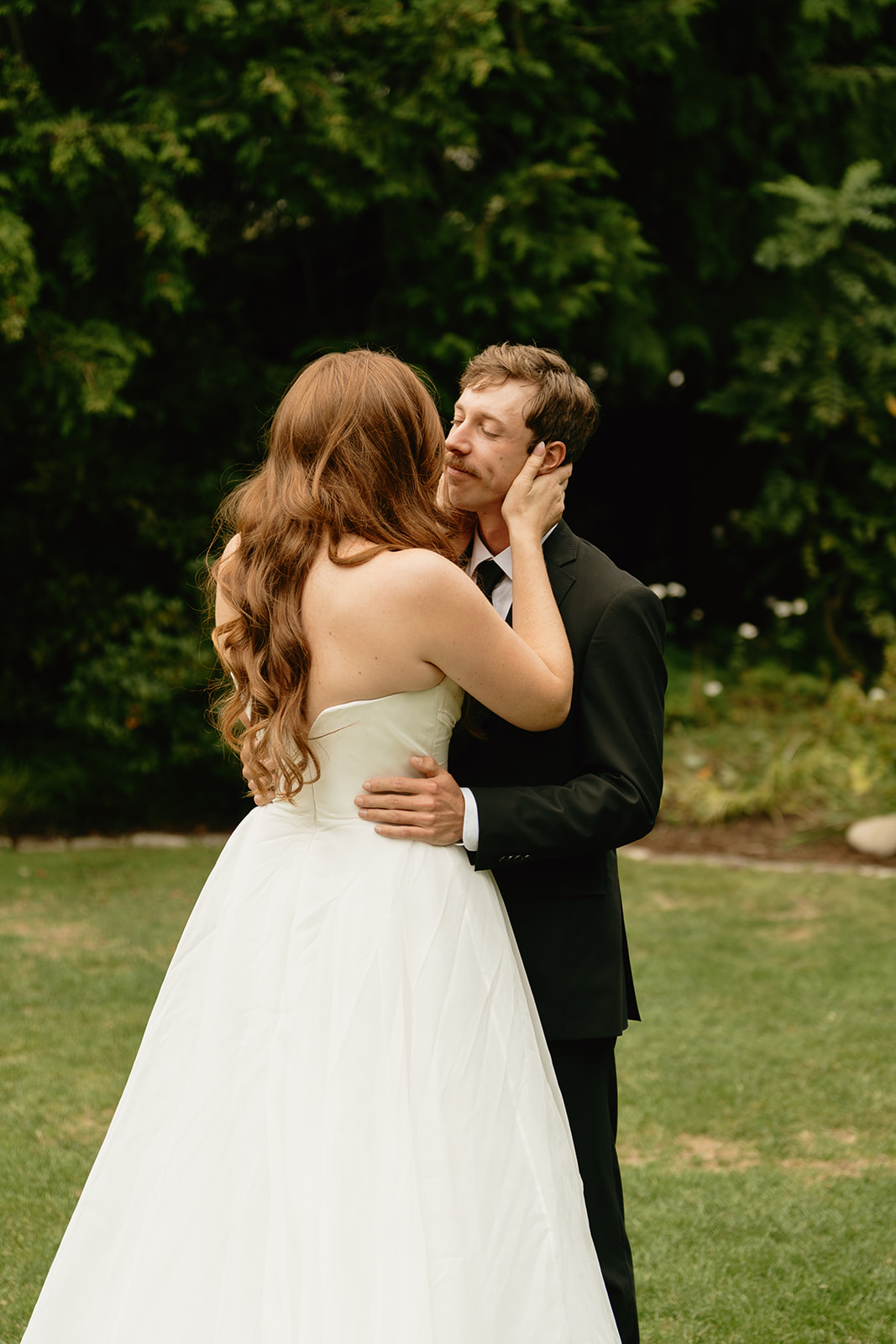 Emotional first look moment during a wedding in Washington, as the couple embraces and shares a soft smile.