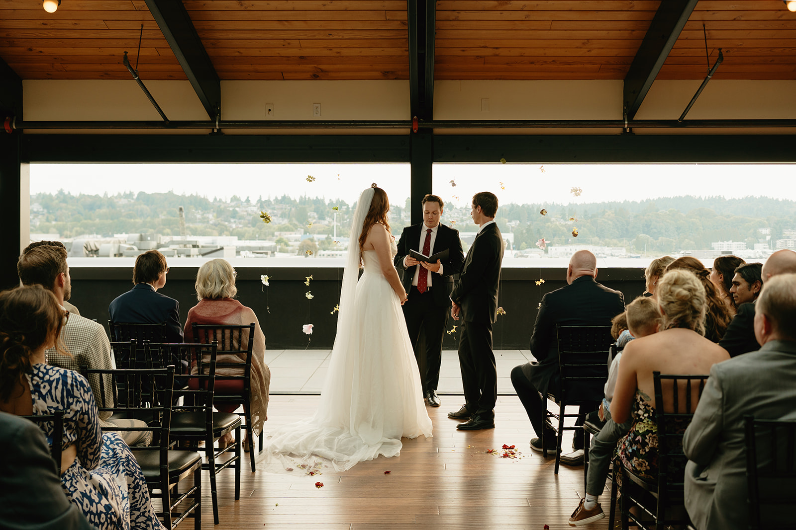 Bride and groom standing hand in hand at the altar, exchanging vows during their intimate wedding ceremony in Washington.
