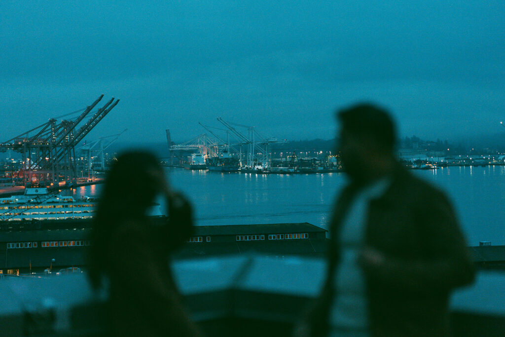 Cinematic couple overlooking the Seattle waterfront at dusk