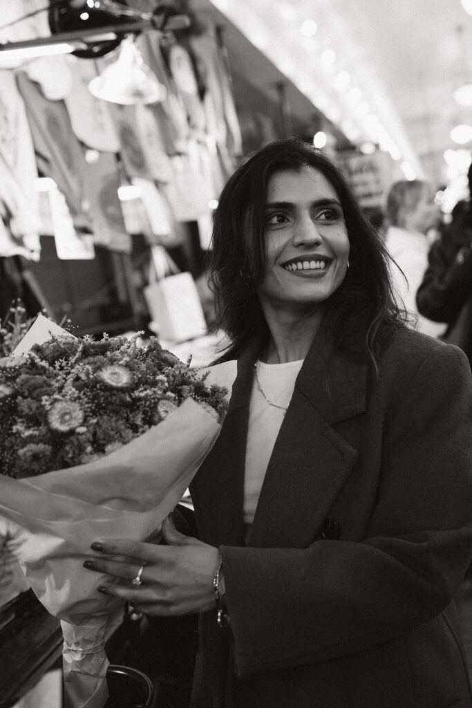 Holding pike place market flowers for a cinematic engagement session
