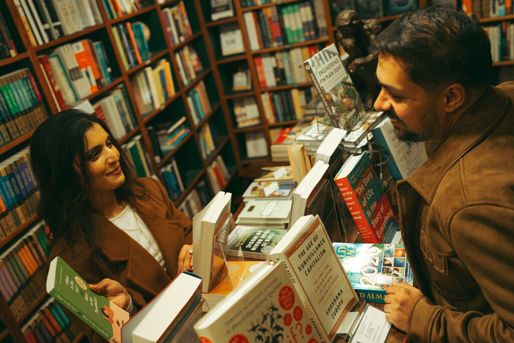 A cinematic couple admiring books at a book store
