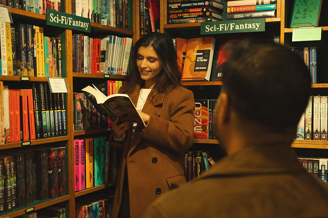 A cinematic couple reading a book in a library