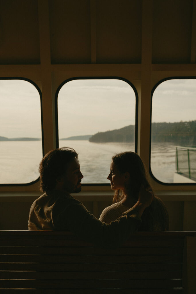 Couple looking at each other while sitting on the Washington State ferry in the San Juan Islands