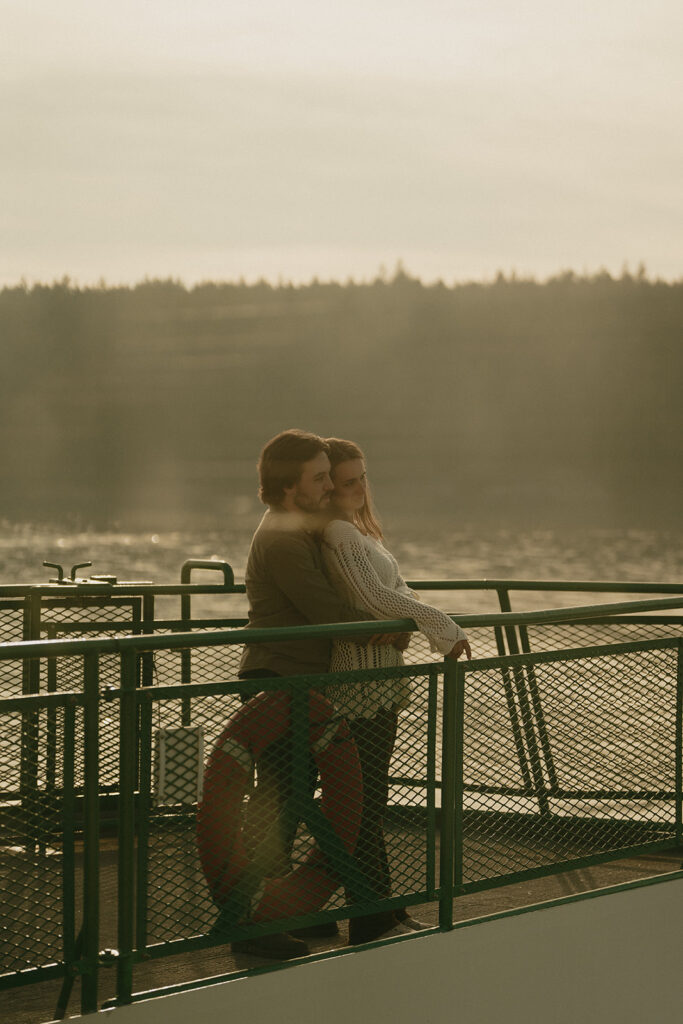 A couple hugging while on a ferry during golden hour in Washington